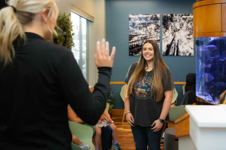 Teen greeted by Greg Brown Orthodontics team