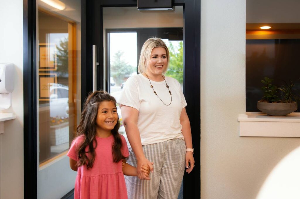 parent accompanying her kid to the dentist clinic at Greg Brown Orthodontics